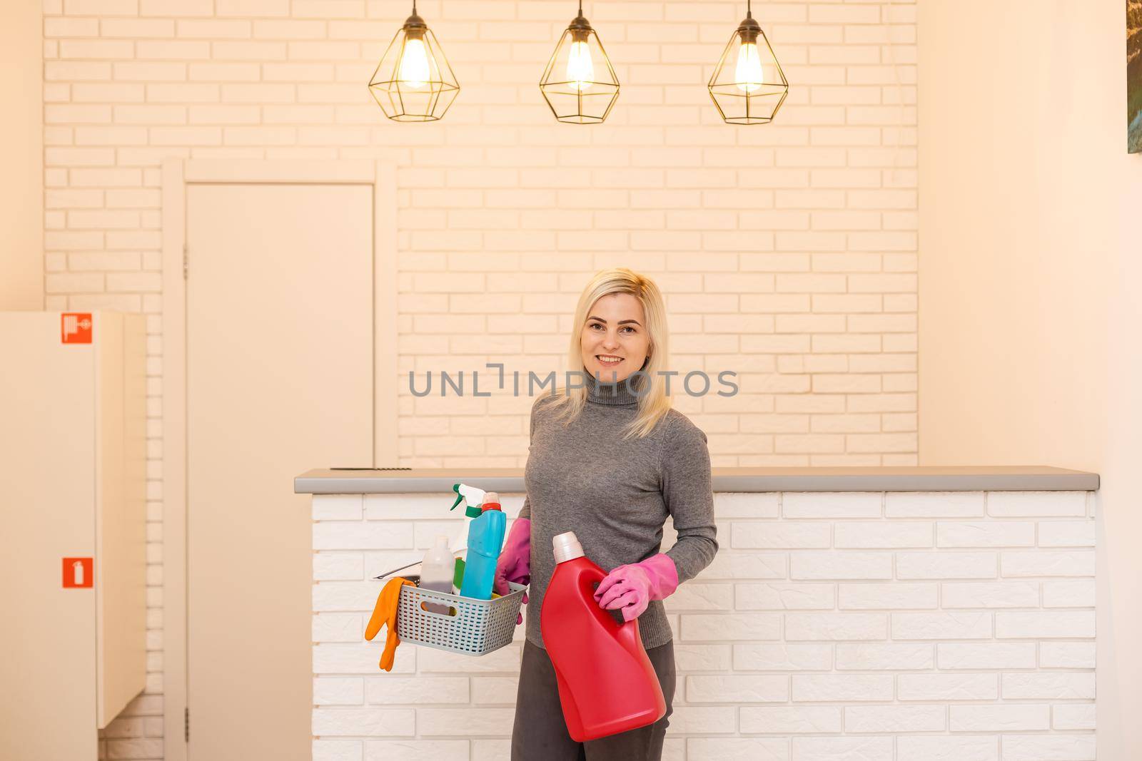 Women at work, portrait of happy professional female cleaner smiling and looking at camera in office.