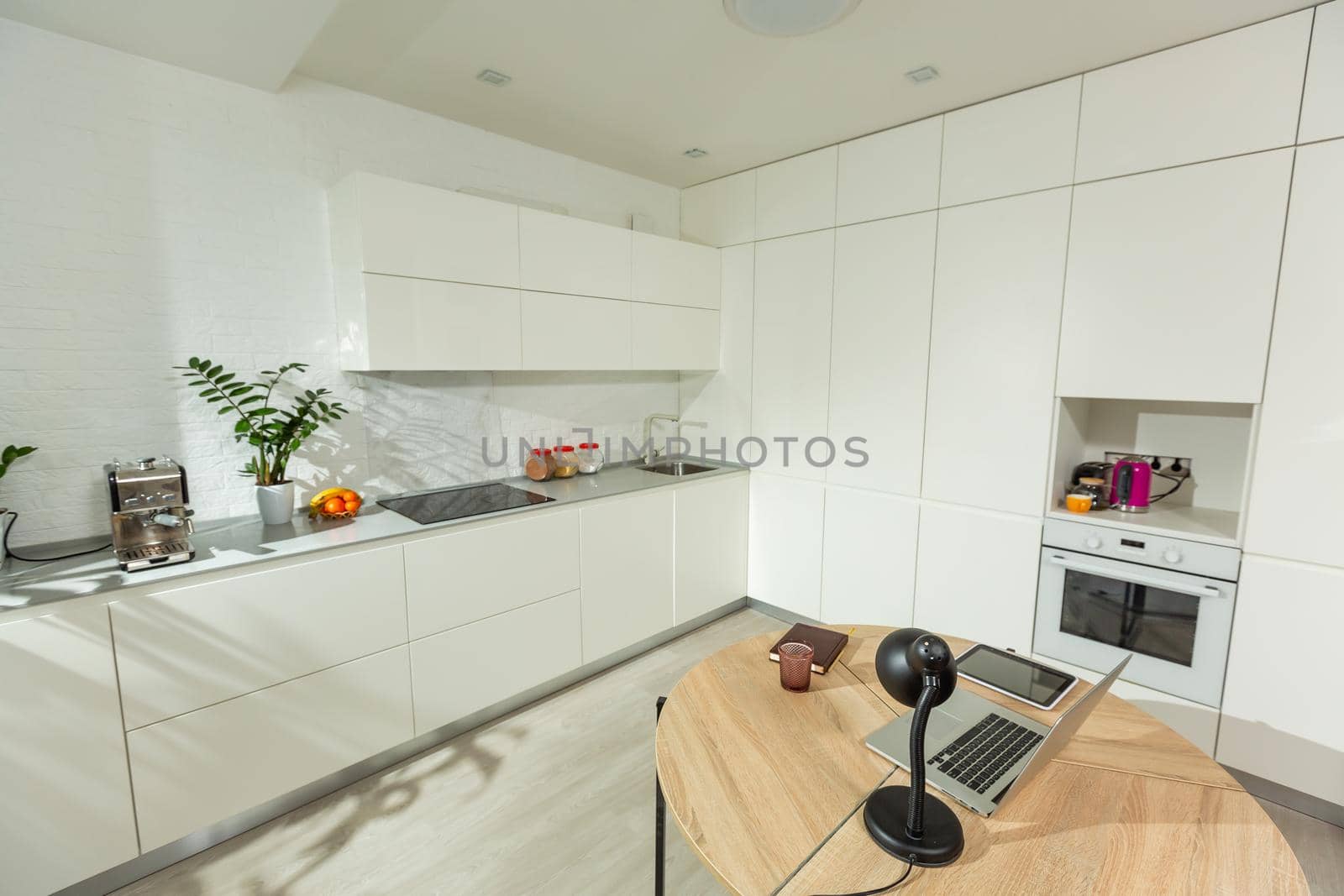 laptop on wood table in modern kitchen room. by Andelov13