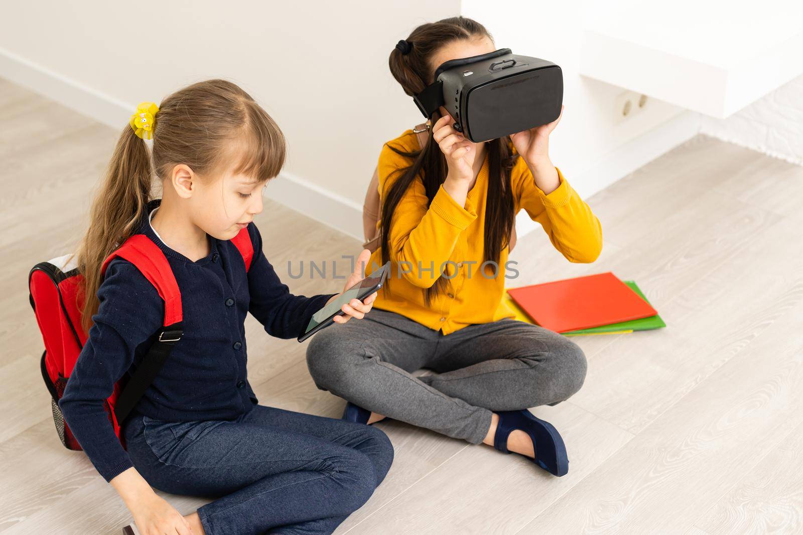 Two girls in headset virtual vr reality. Childhood kids education lifestyle concept by Andelov13