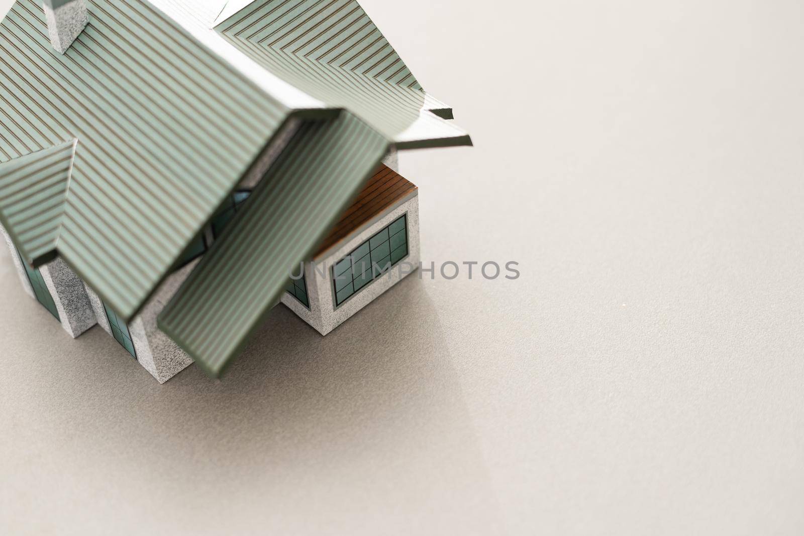 Volumetric project of house. Layout of a house with an open roof. Miniature layout of a cottage top view. Building model as a symbol of architectural business. Design in architectural bureau. by Andelov13