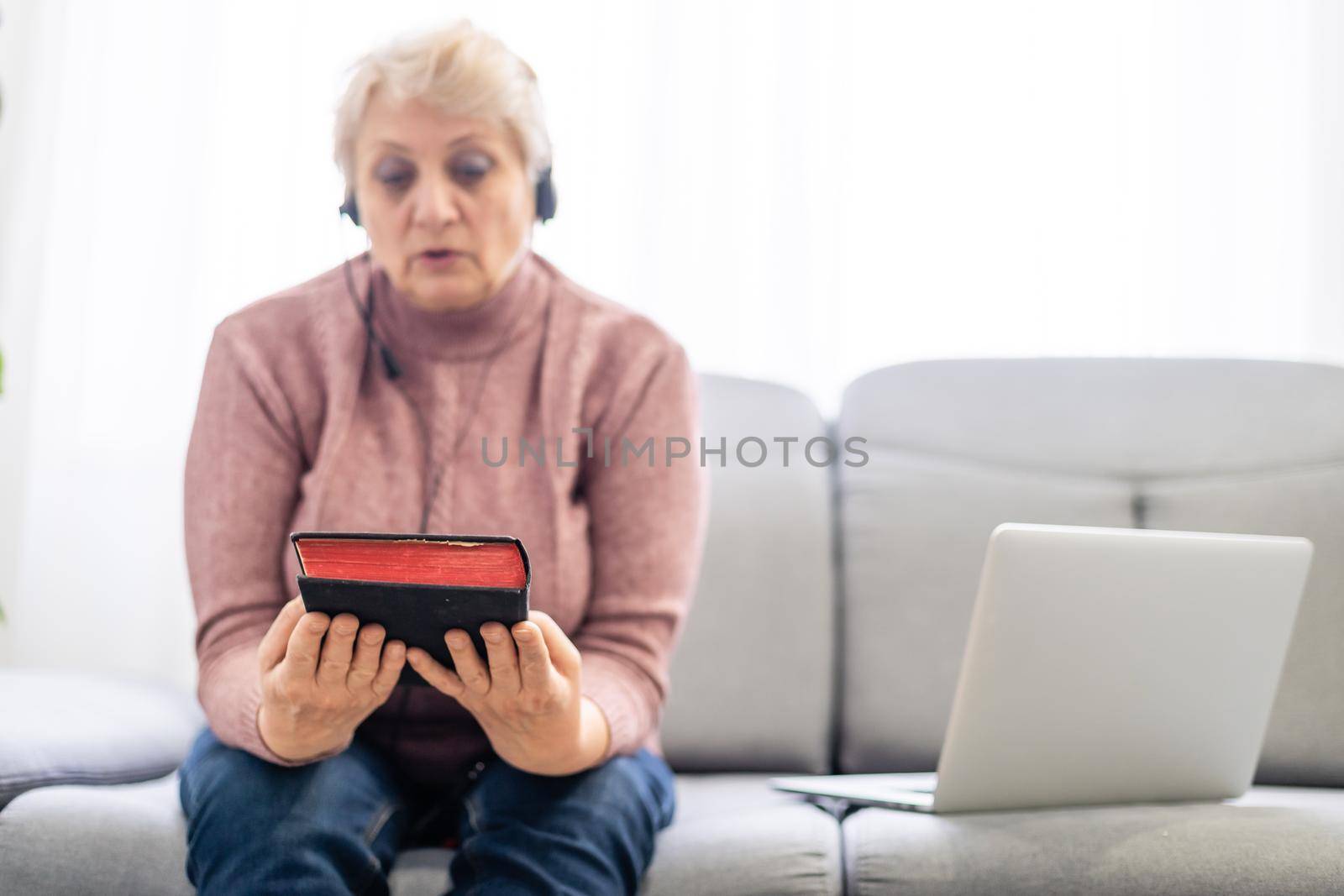 Woman praying and worship to god with church online sunday service. Live church with bible. woman pray to god. Hand praying and palm up on holy bible at home. Quarantine from Covid-19 Coronavirus pandemic.