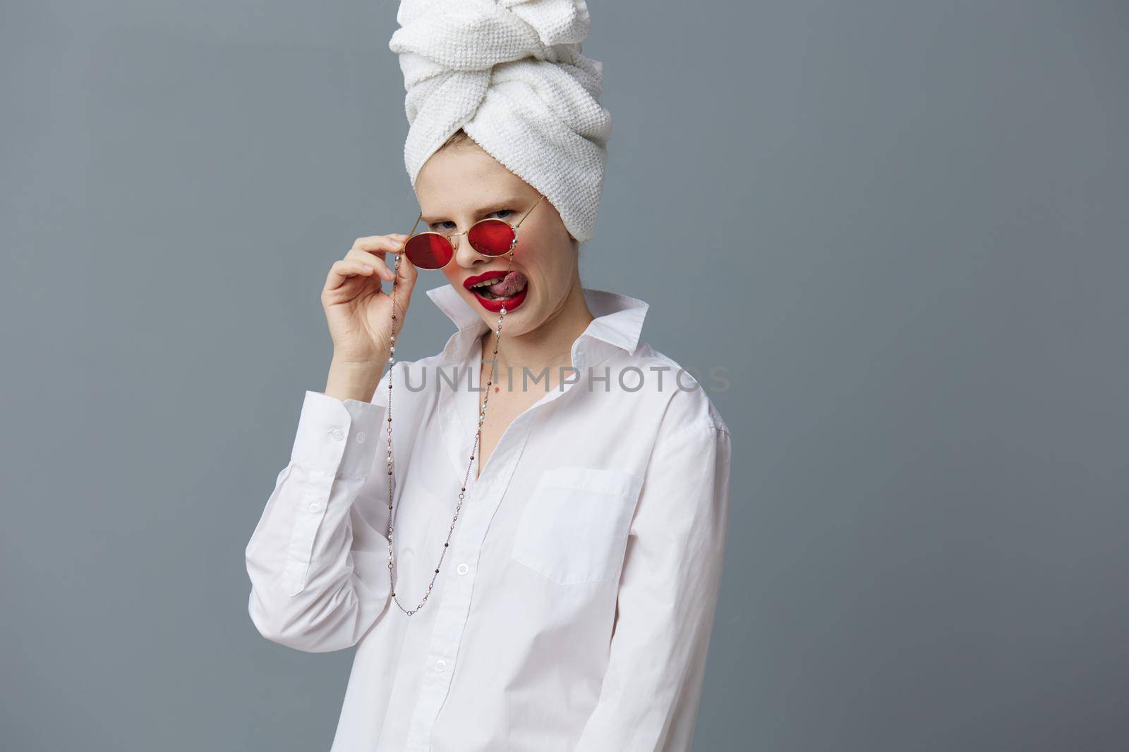 woman red glasses towel on head makeup studio model unaltered. High quality photo