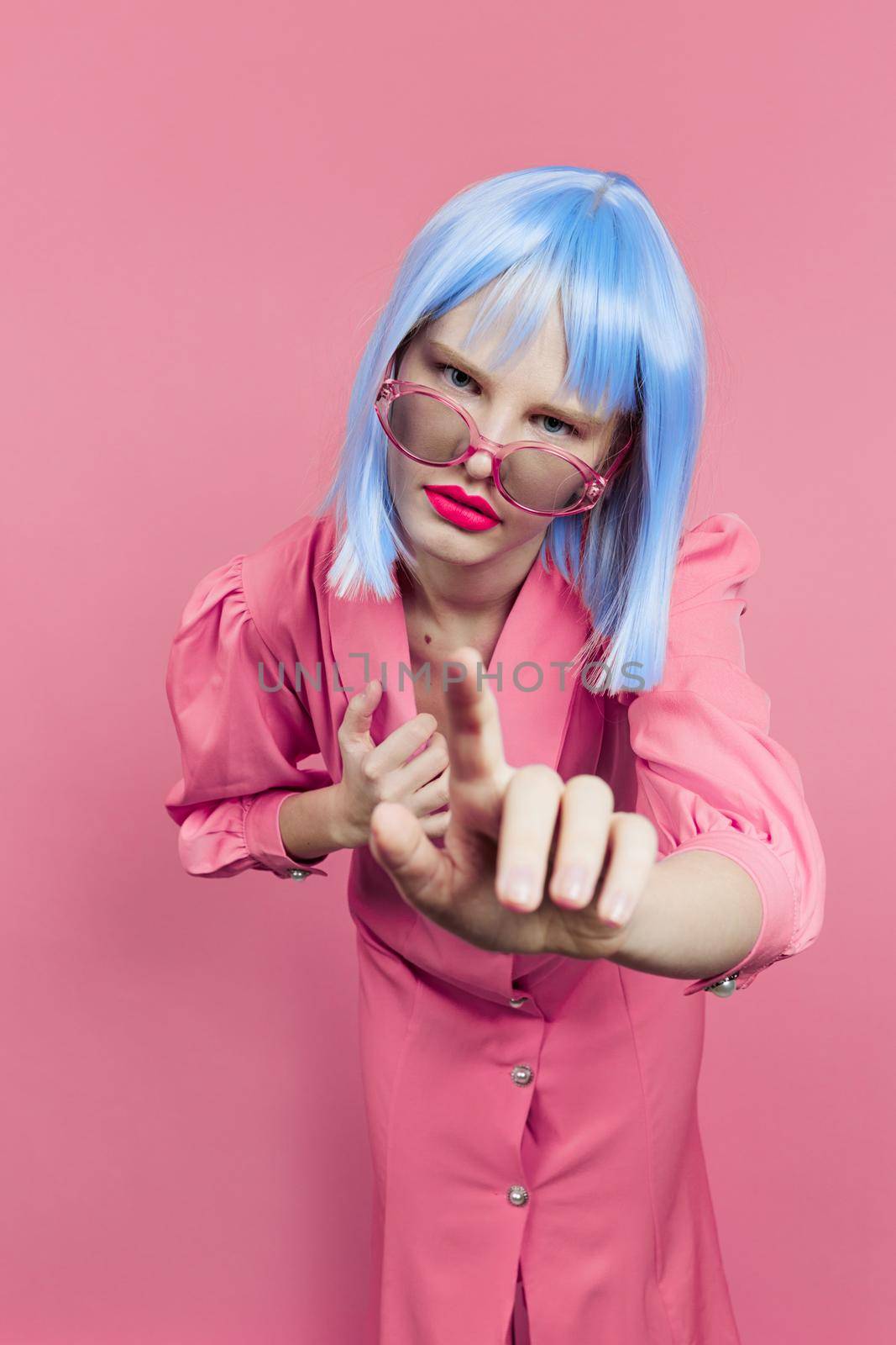 fashionable woman in sunglasses wears a blue wig makeup isolated background by SHOTPRIME