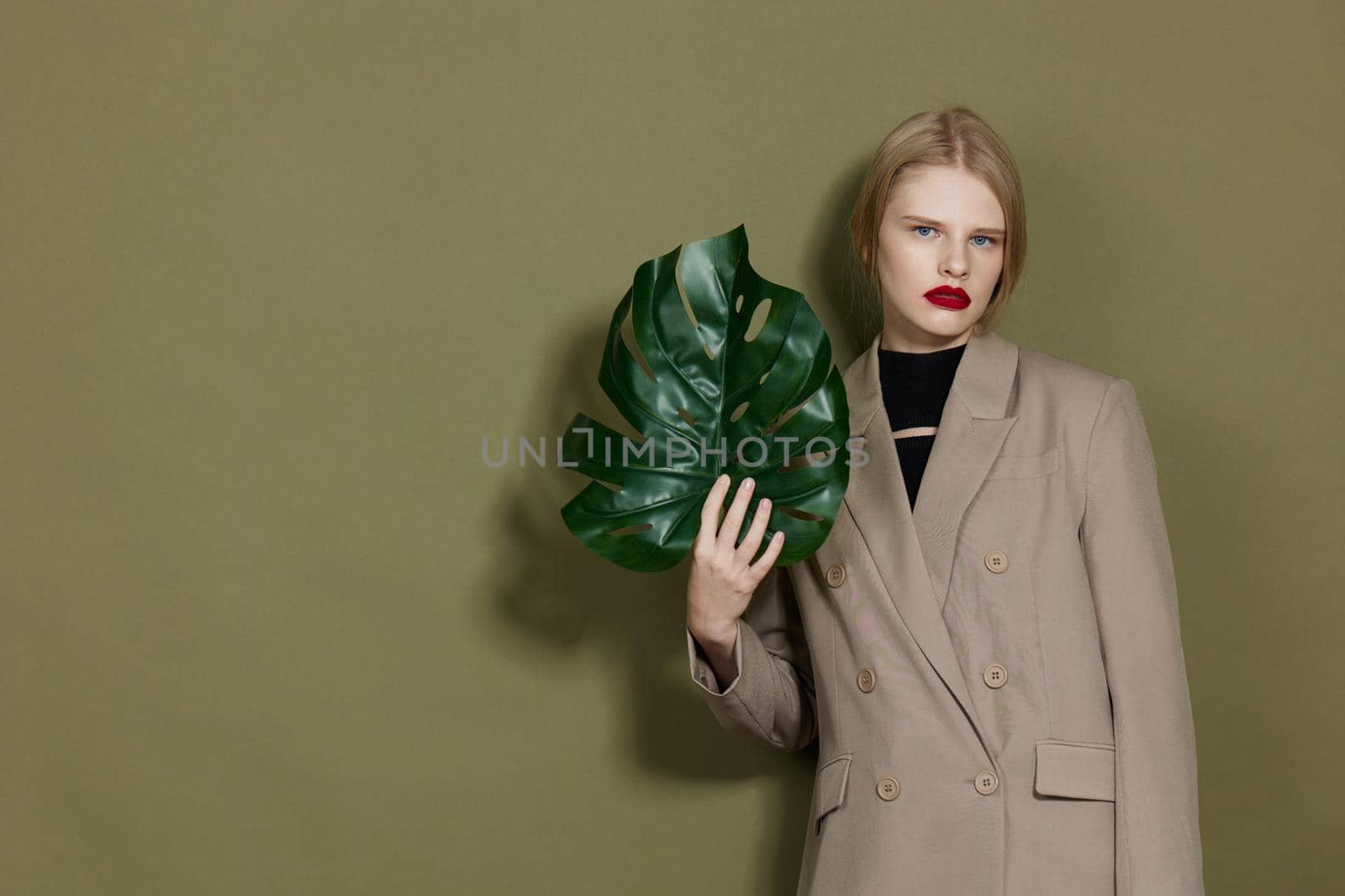 portrait of a woman green palm leaf coat bright makeup Lifestyle posing by SHOTPRIME