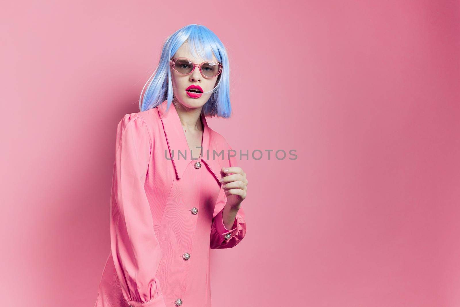 glamorous woman in sunglasses wears a blue wig makeup studio model. High quality photo