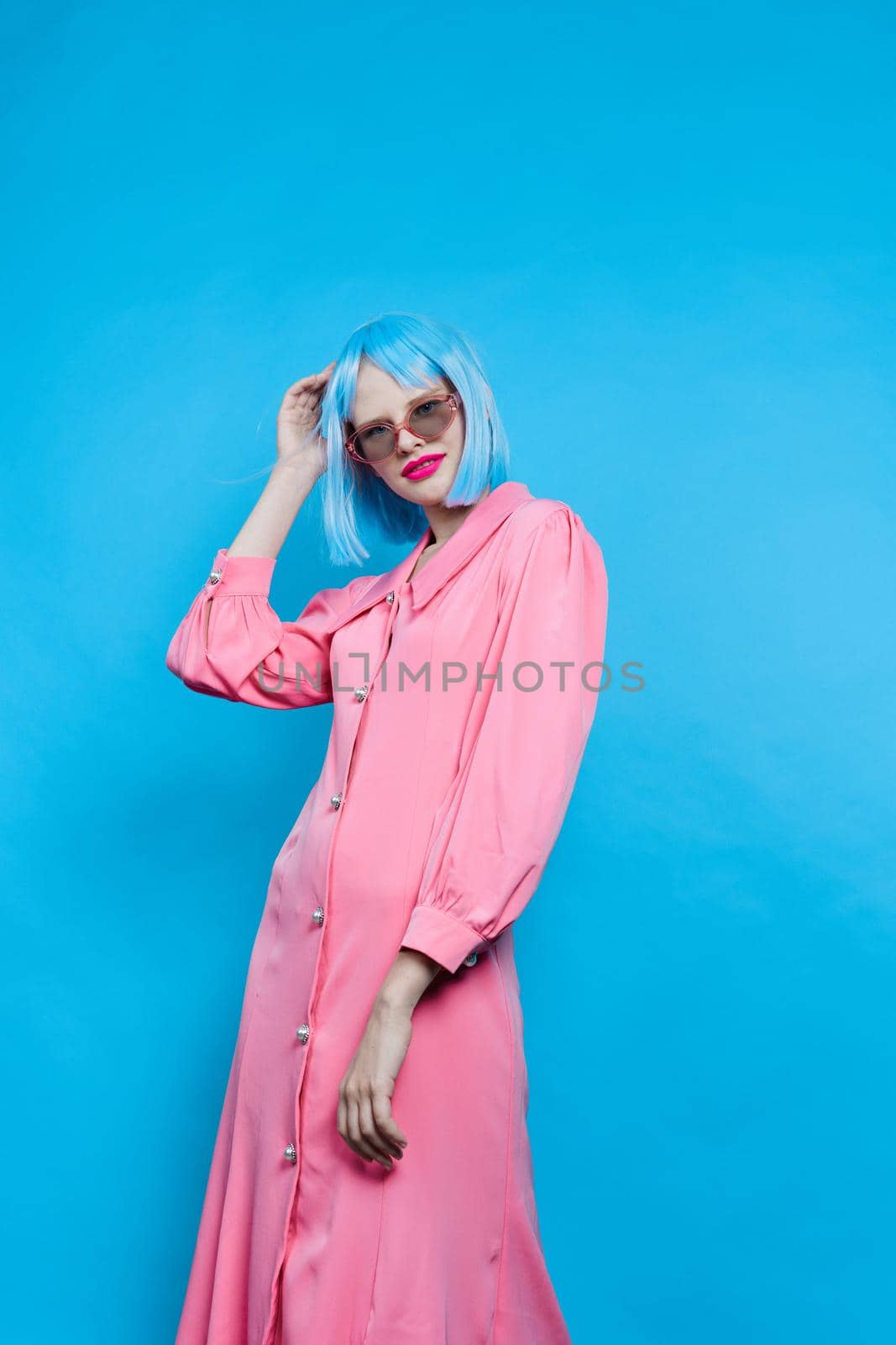 pretty woman in sunglasses wears a blue wig makeup Lifestyle posing. High quality photo