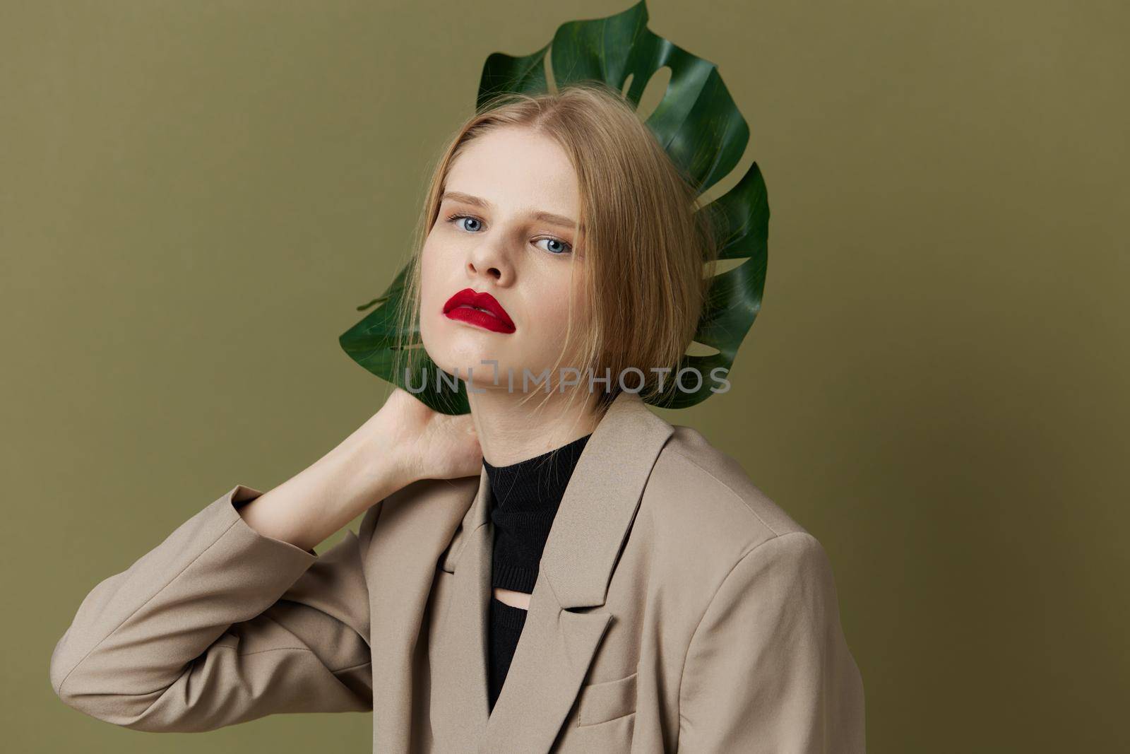 fashionable woman in coat red lips fashion palm leaf Lifestyle posing. High quality photo