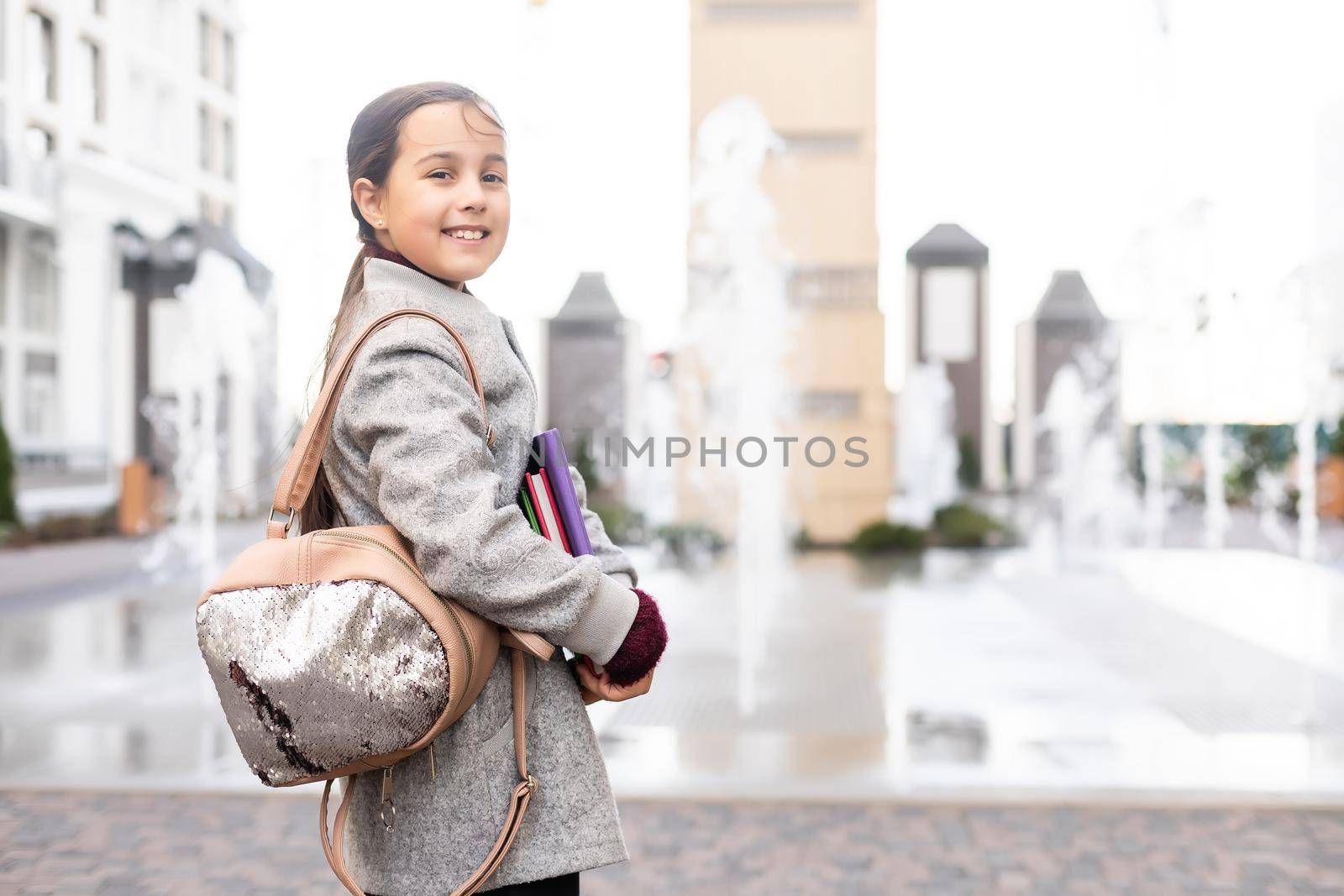 Beautiful little schoolgirl with a backpack by Andelov13