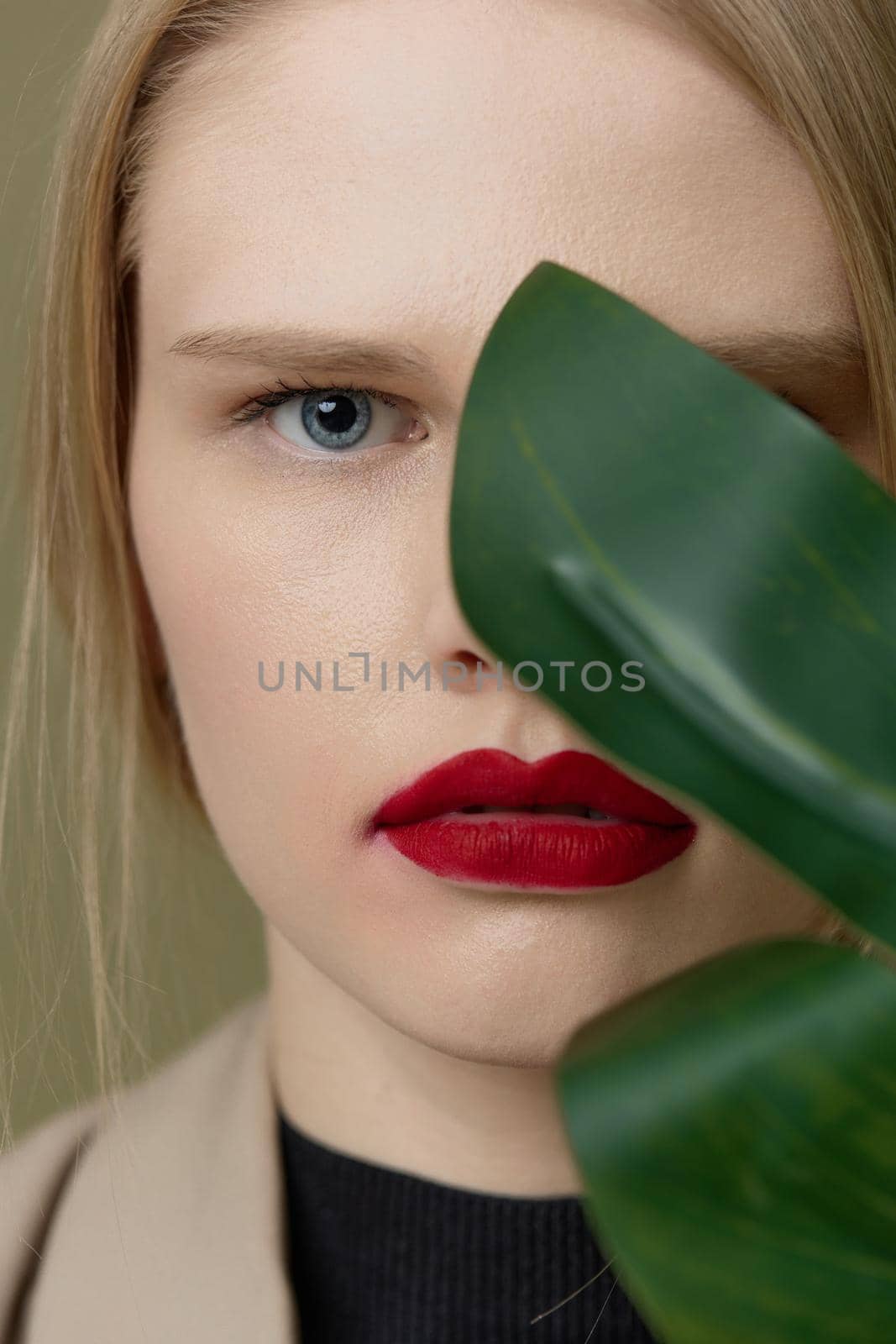 blonde woman red lips palm leaf charm fashion Lifestyle posing. High quality photo