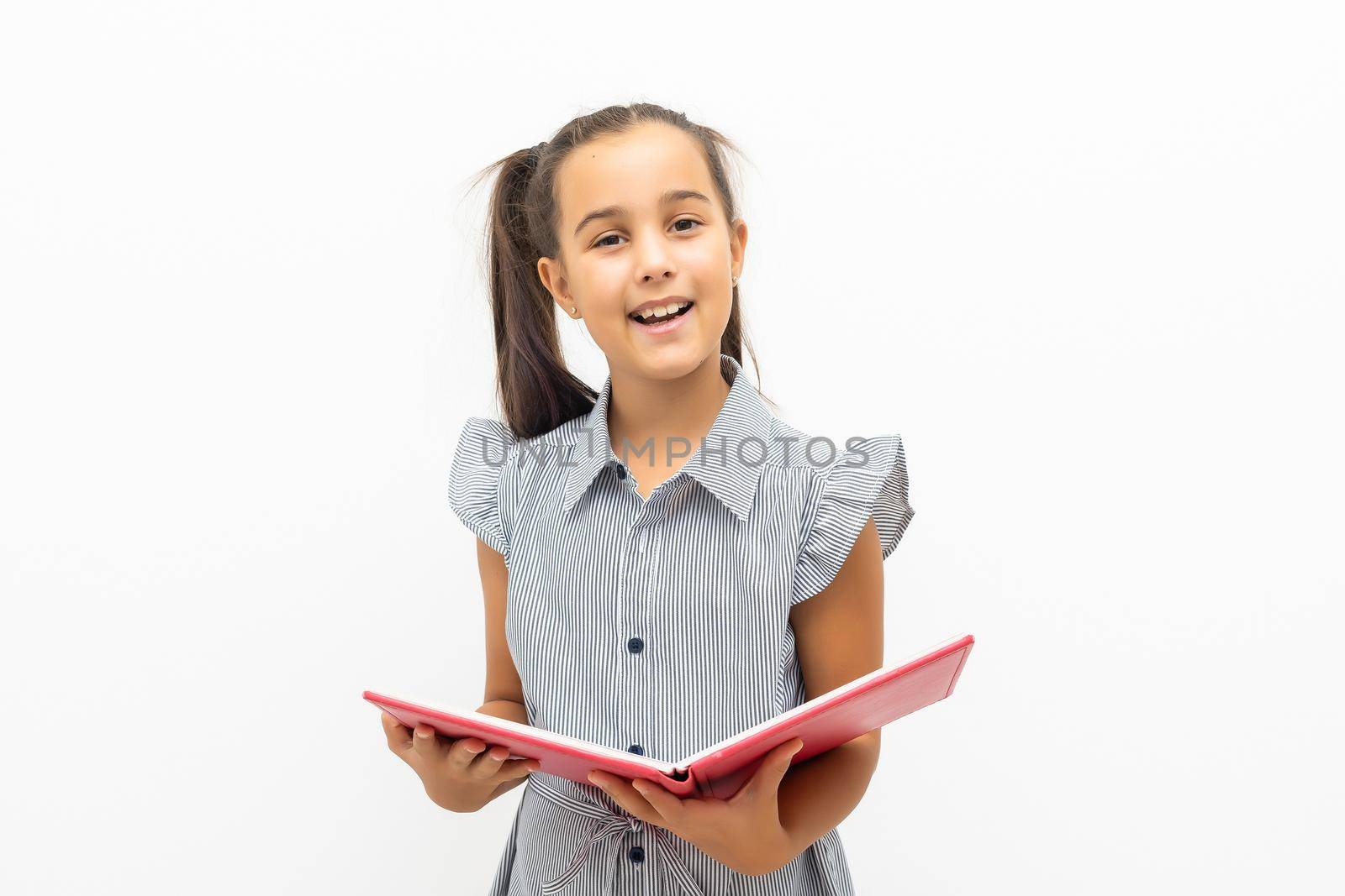 Little girl holding a big book. Isolated on white background by Andelov13