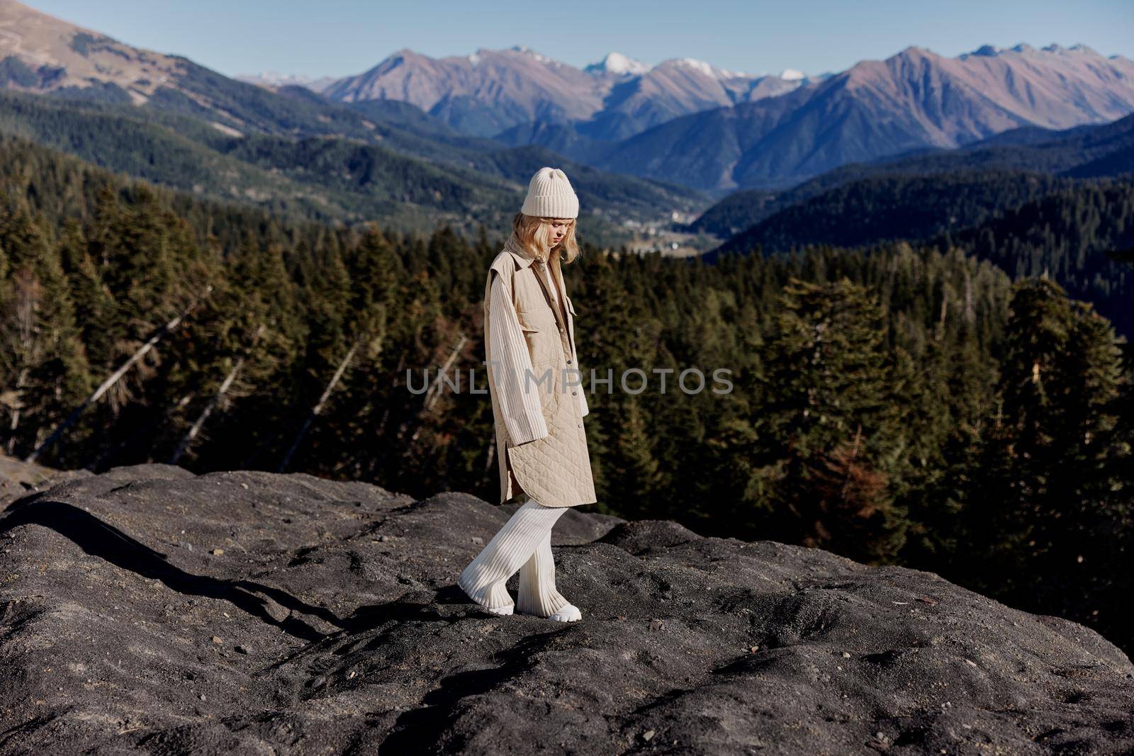 young woman Standing on the edge of a cliff nature travel relaxation. High quality photo