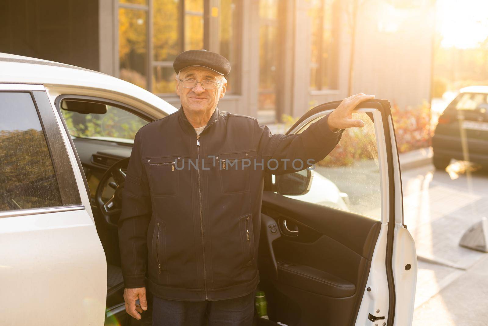 Elderly person driving a car. elderly man in a car