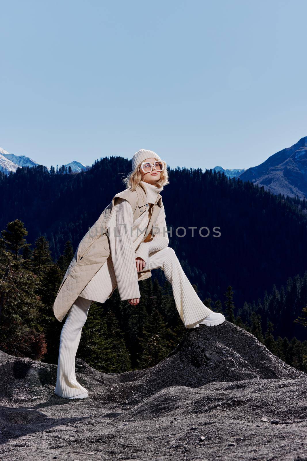 Stylish woman fashion glasses mountain top nature freedom landscape. High quality photo