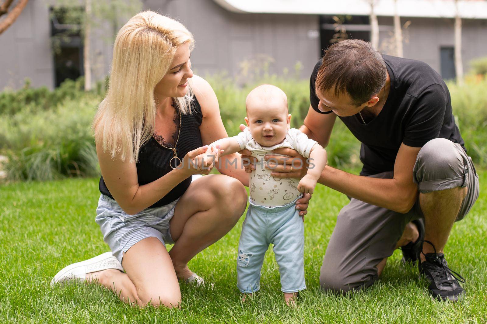 Happy family: mother father and child on nature.