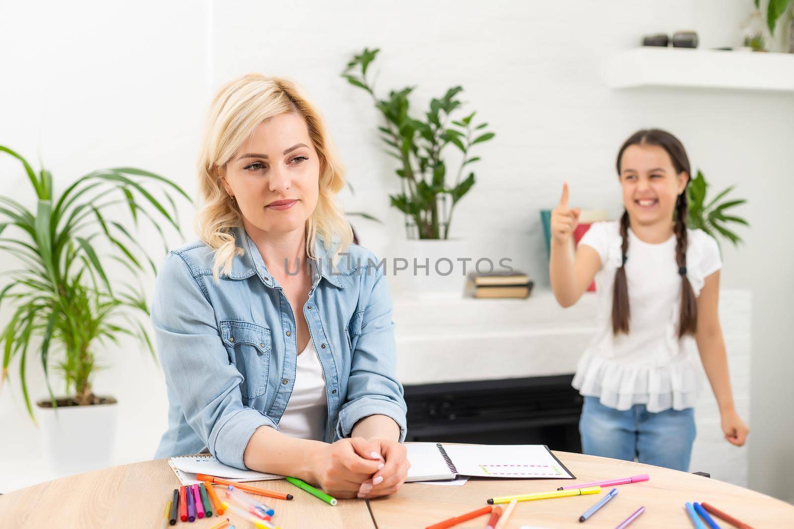 A mother helping her daughter with homework.