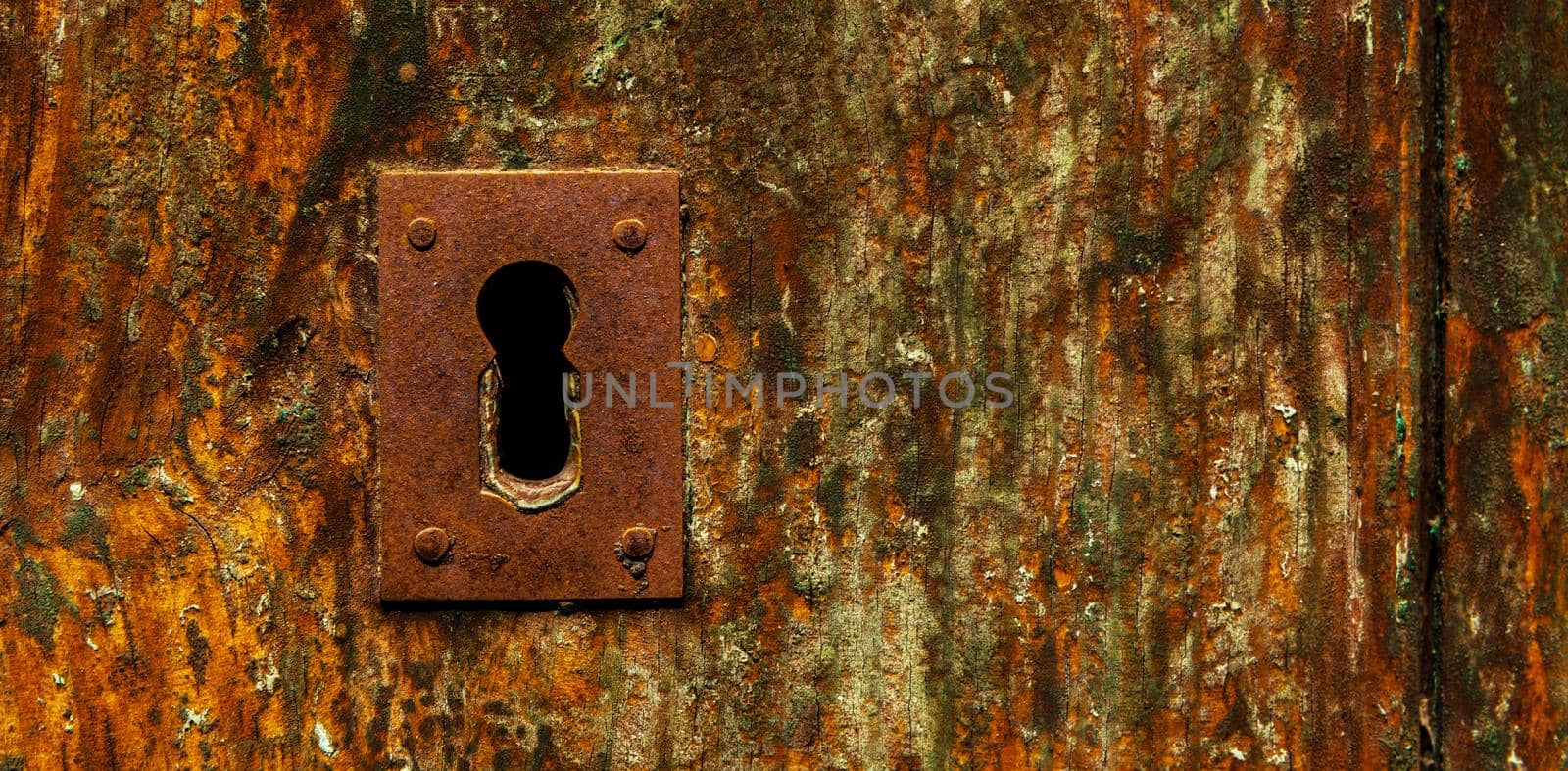 keyhole in an old door with an interesting texture, a remnant of an old entrance security by Q77photo