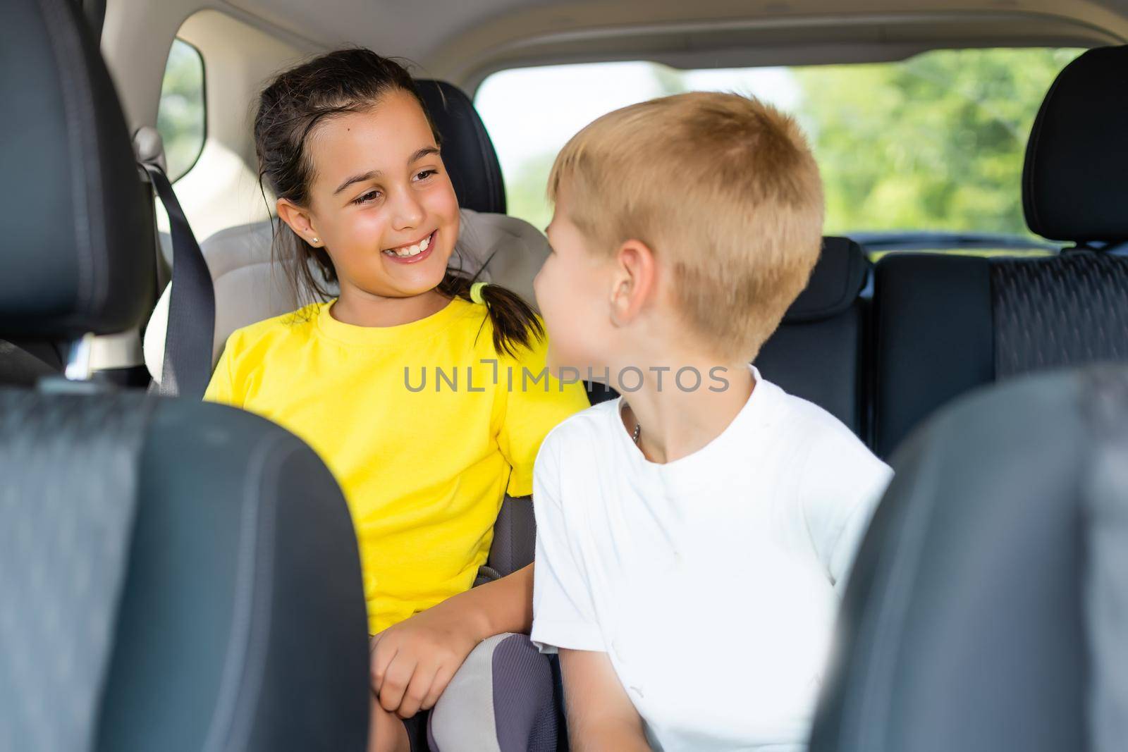 Cute children in car, boy and girl in the car