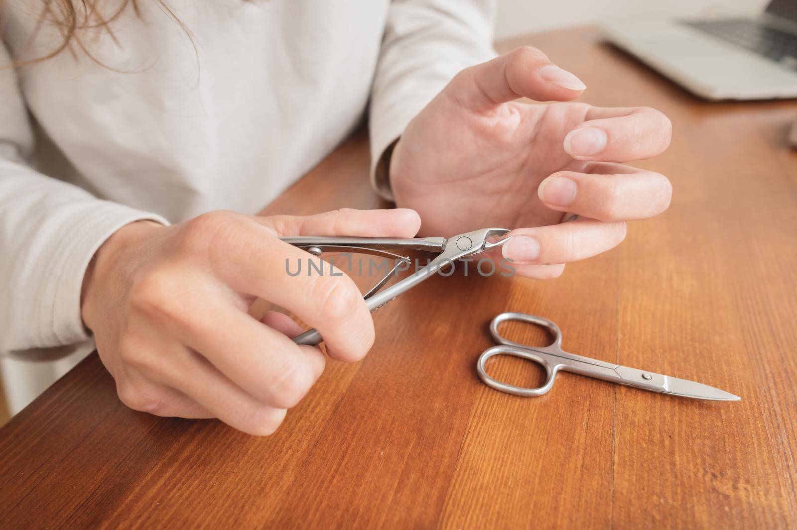 Close-up Cuticle remover. Edged manicure nippers at home. Tools for manicure