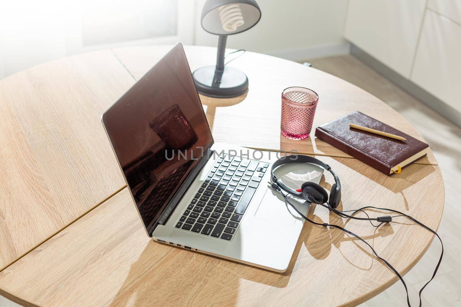 Laptop on table, home interior.