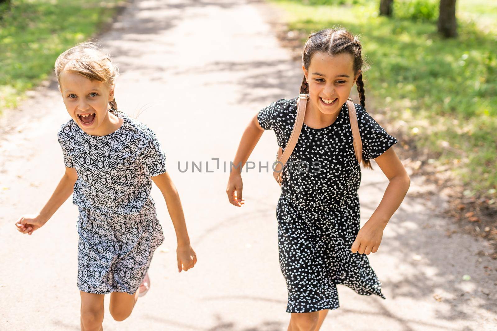 Back to school. First day of school. Two teenage girs at the school feeling happy and excited