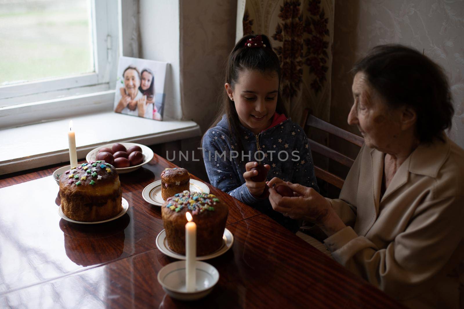 senior woman with easter eggs and Easter cake by Andelov13