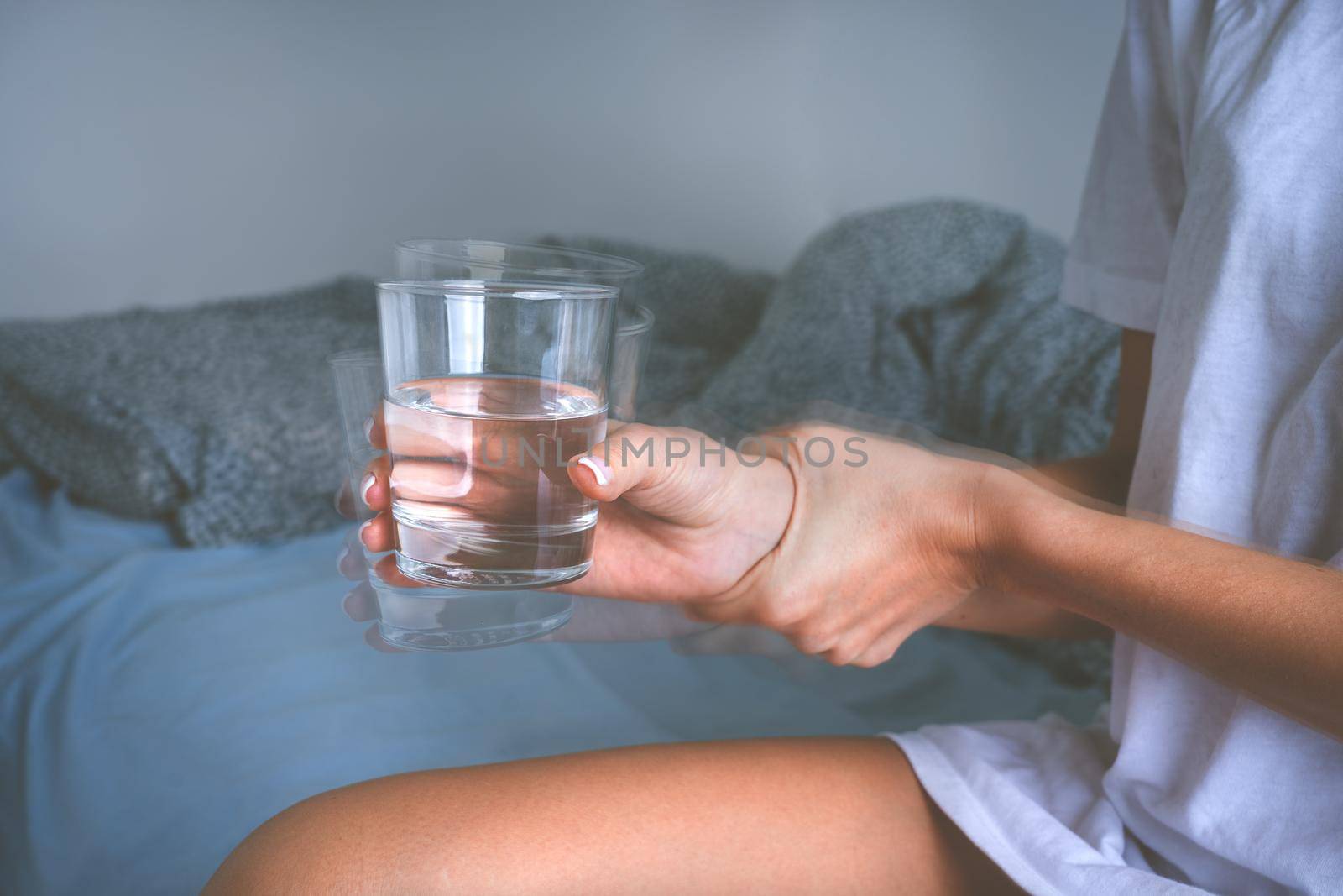 Tremor or shaking hands. Woman with shaky hands suffering from Parkinson's disease symptoms or essential tremor. by DariaKulkova