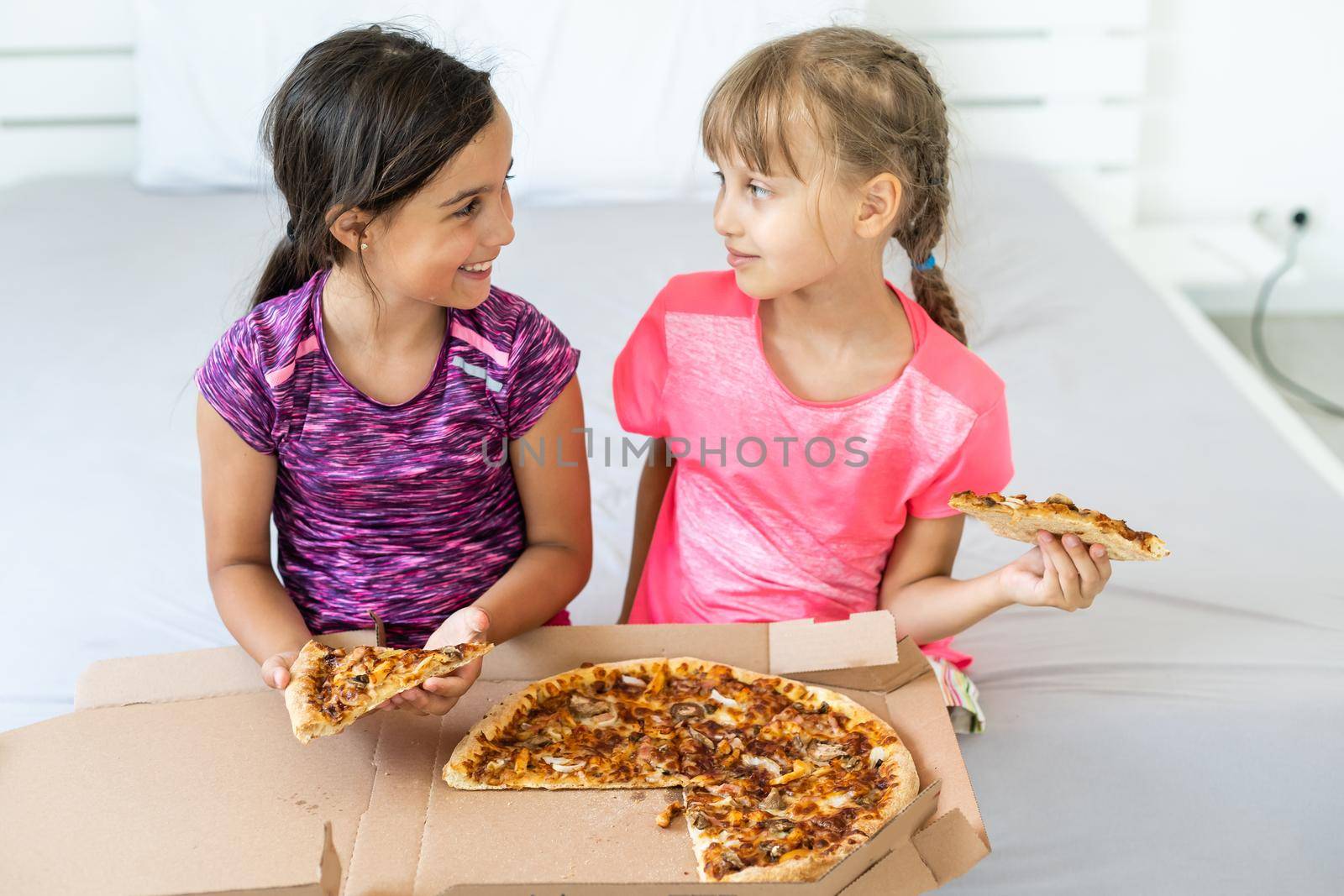 Young girls eating pizza. High quality photo