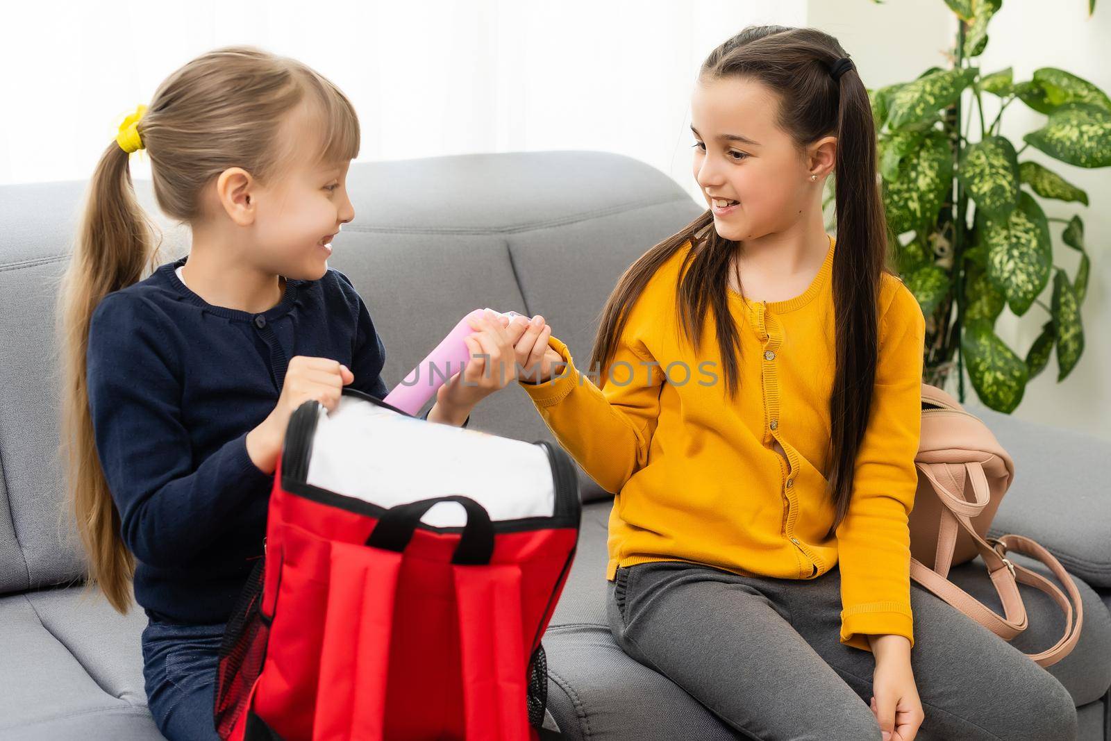 Children go back to school. Start of new school year after summer vacation. girls with backpack and books on first school day. Beginning of class. Education for kindergarten and preschool kids