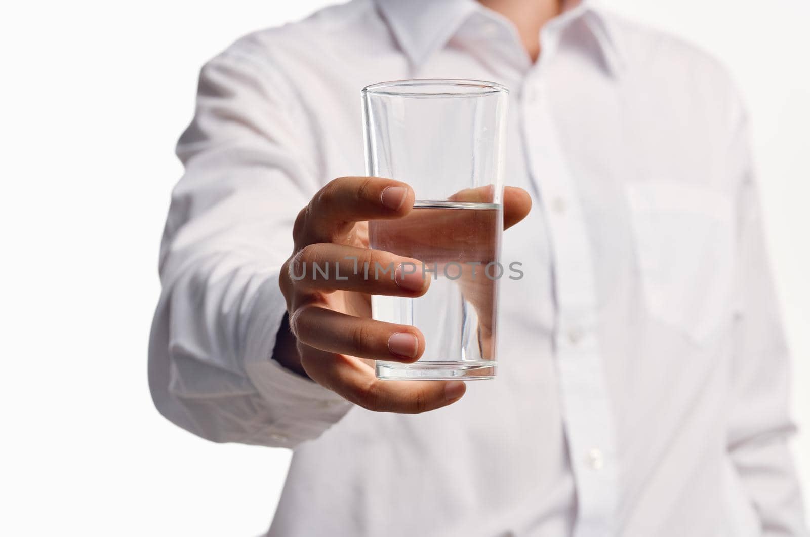 bearded man drinking water light background. High quality photo