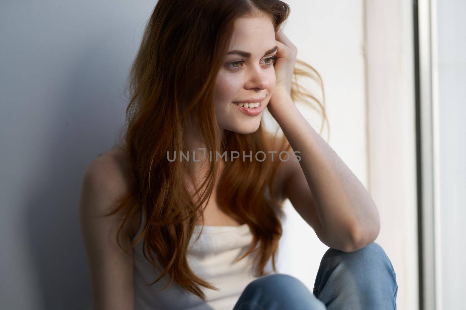 pretty woman sitting near the window smile rest at home. High quality photo