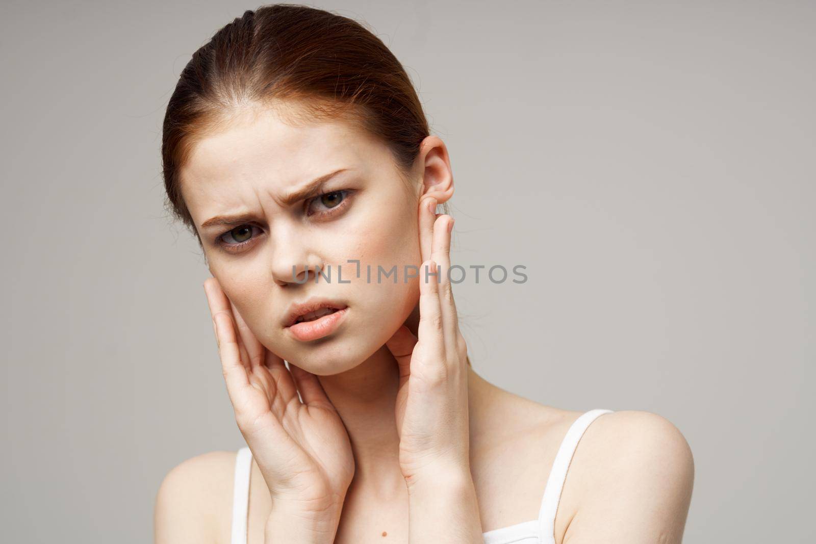 sick woman ear pain otitis media health problems infection studio treatment. High quality photo
