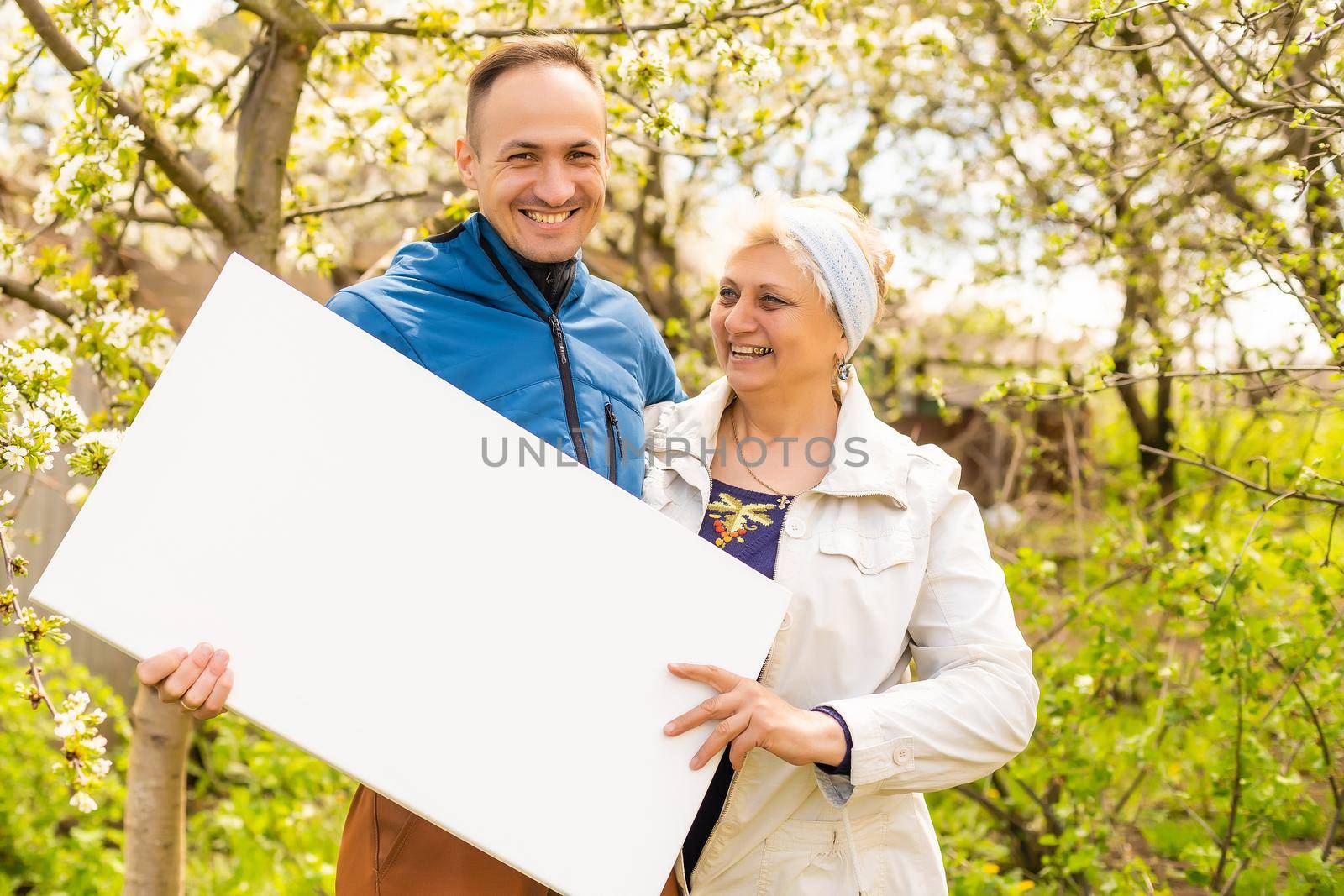 elderly woman holds a photo canvas by Andelov13