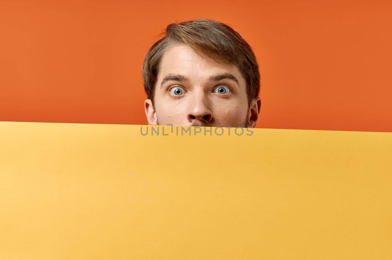 bearded man holding a yellow banner design isolated background by SHOTPRIME