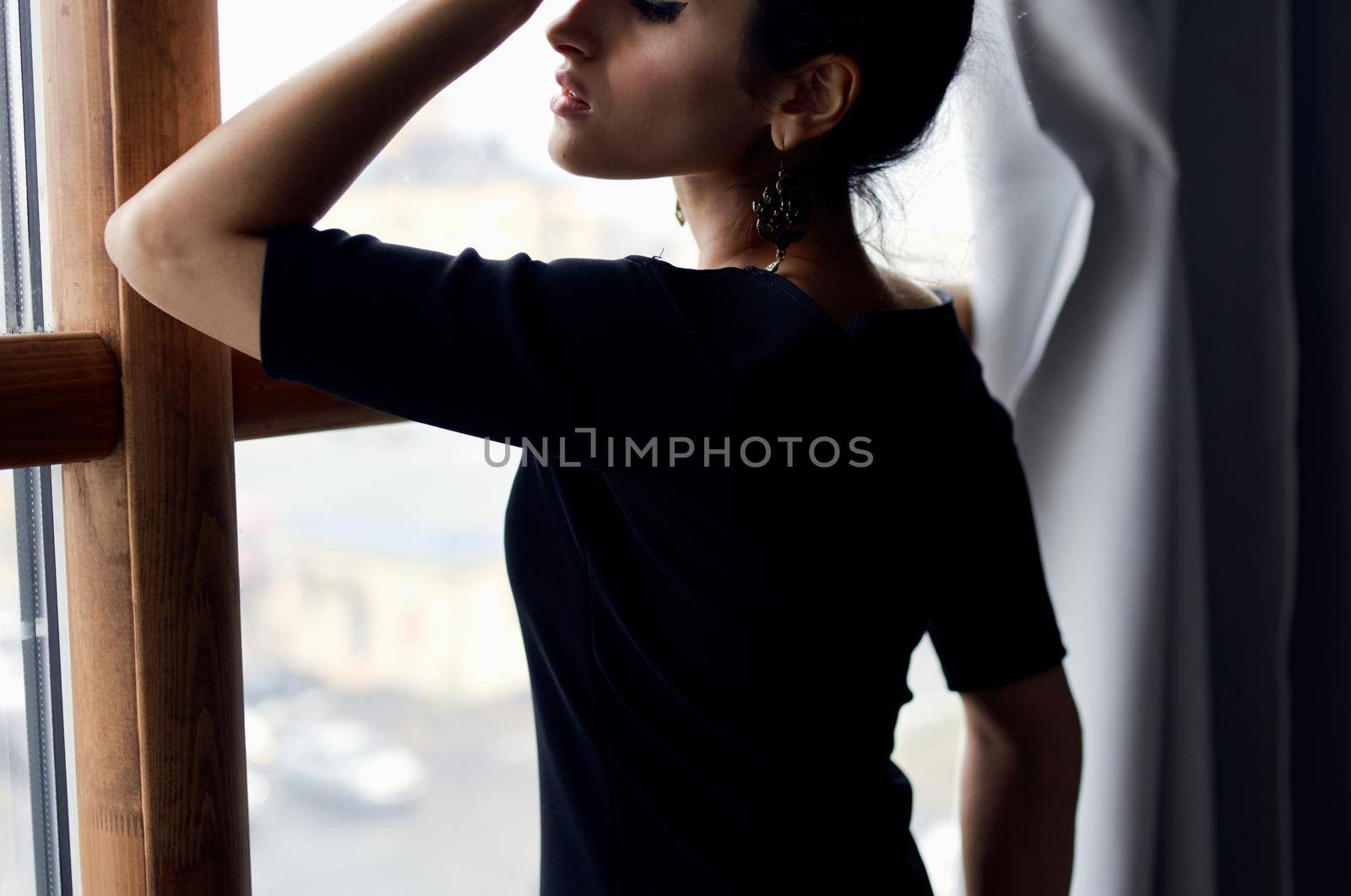 beautiful woman in a black dress near the window posing elegant style by SHOTPRIME