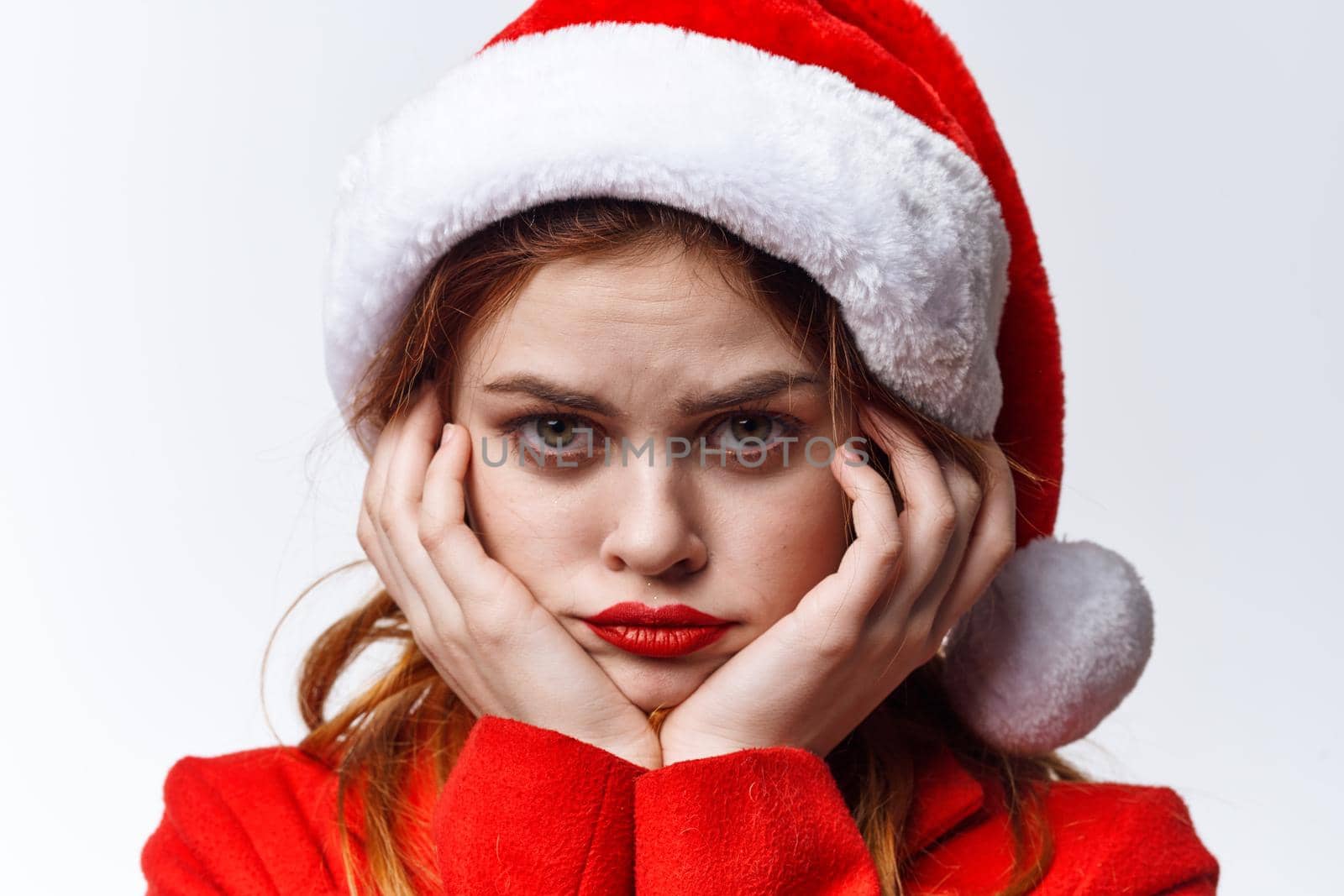woman in santa hat red lips emotions posing holiday. High quality photo