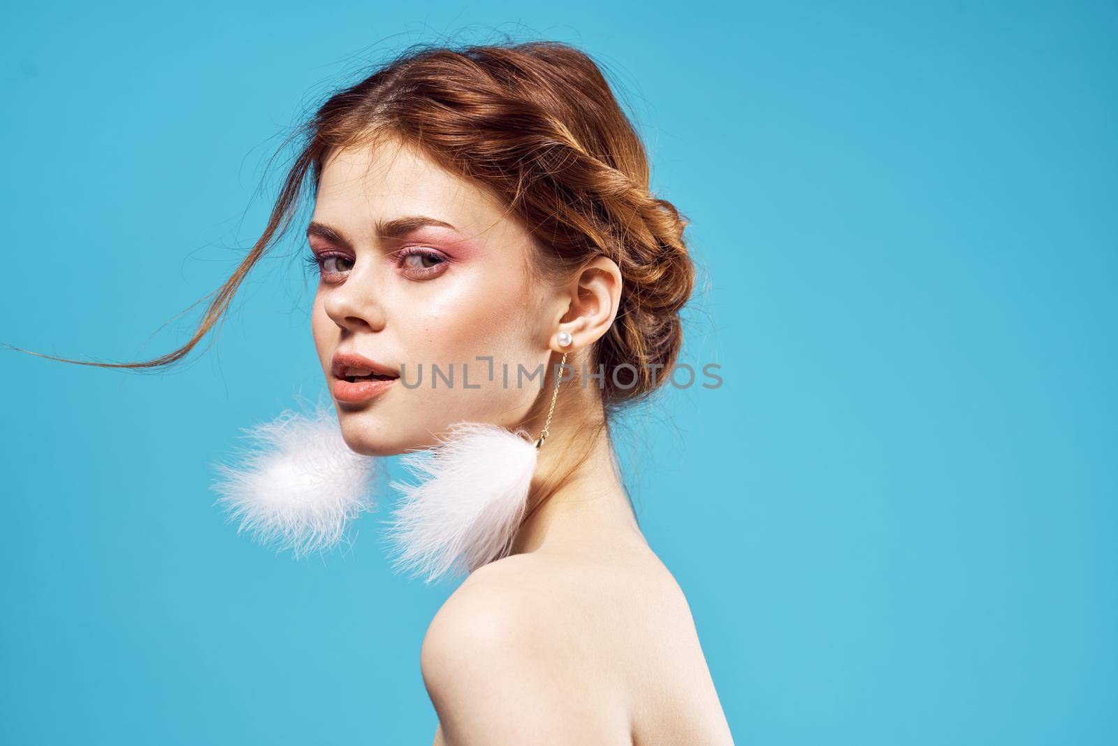 sexy woman with bare shoulders bright makeup fashion luxury blue background. High quality photo