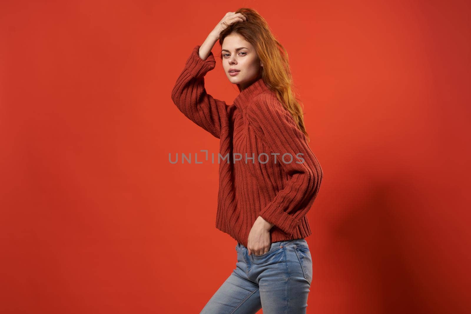 woman in a red sweater beautiful hairstyle fashion lifestyle close-up. High quality photo