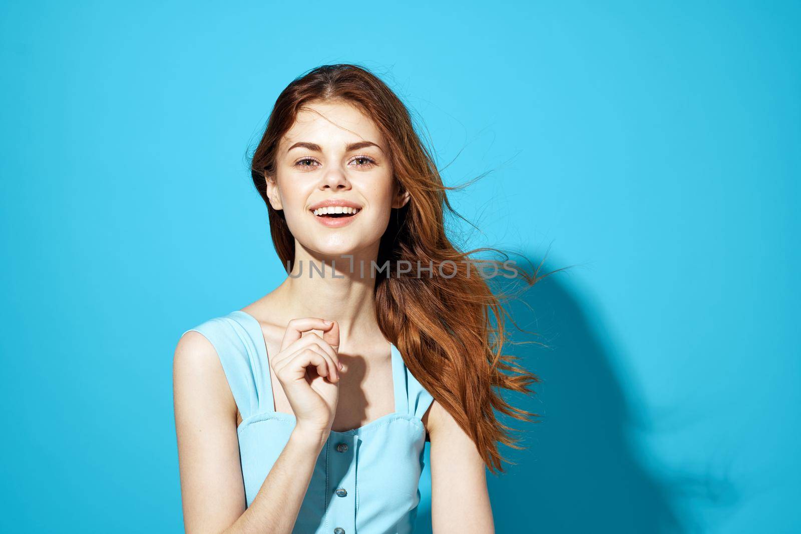 beautiful woman in a blue dress posing Studio fun model. High quality photo
