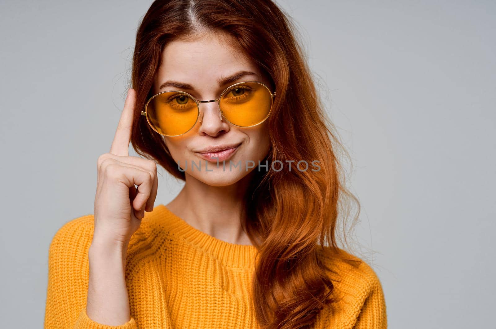 beautiful woman in yellow glasses posing fun lifestyle light background. High quality photo
