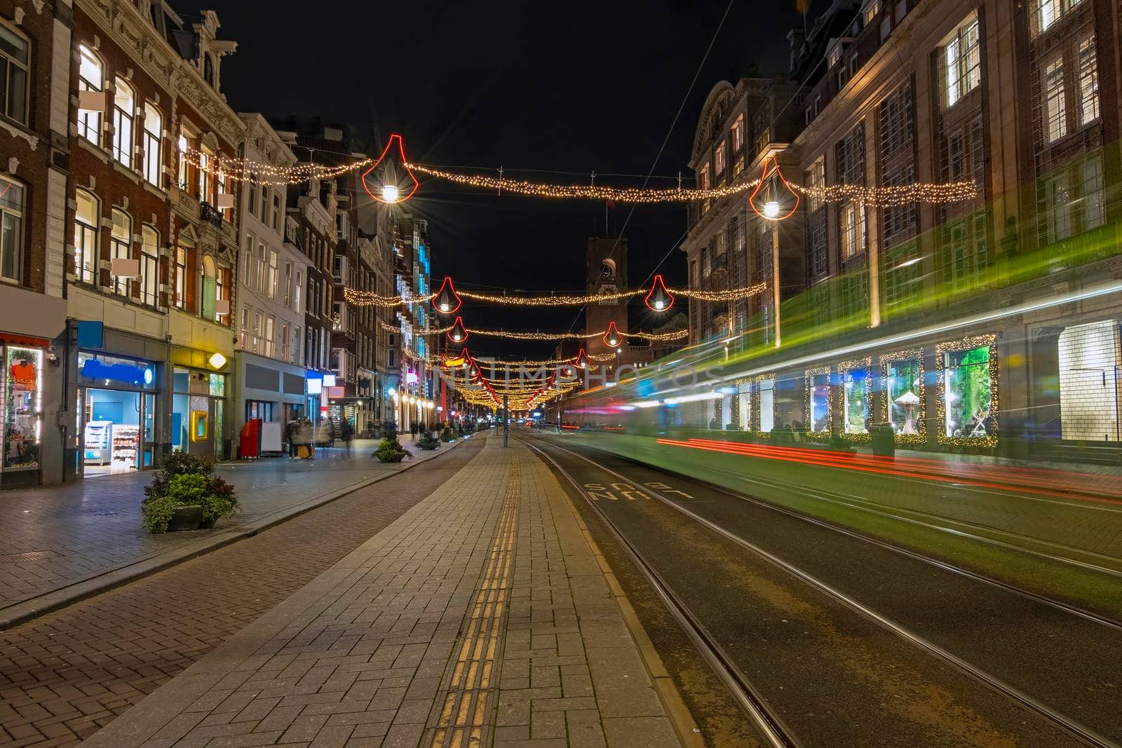 Tram driving on Damrak in christmas time in Amsterdam Netherlands by devy