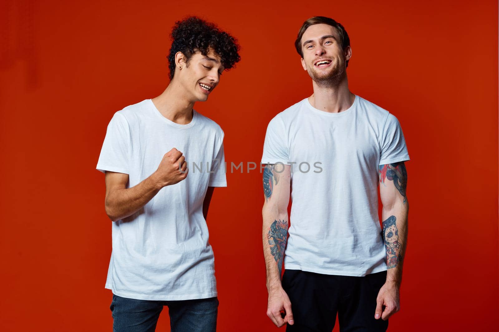 funny two friends in white t-shirts posing Studio. High quality photo