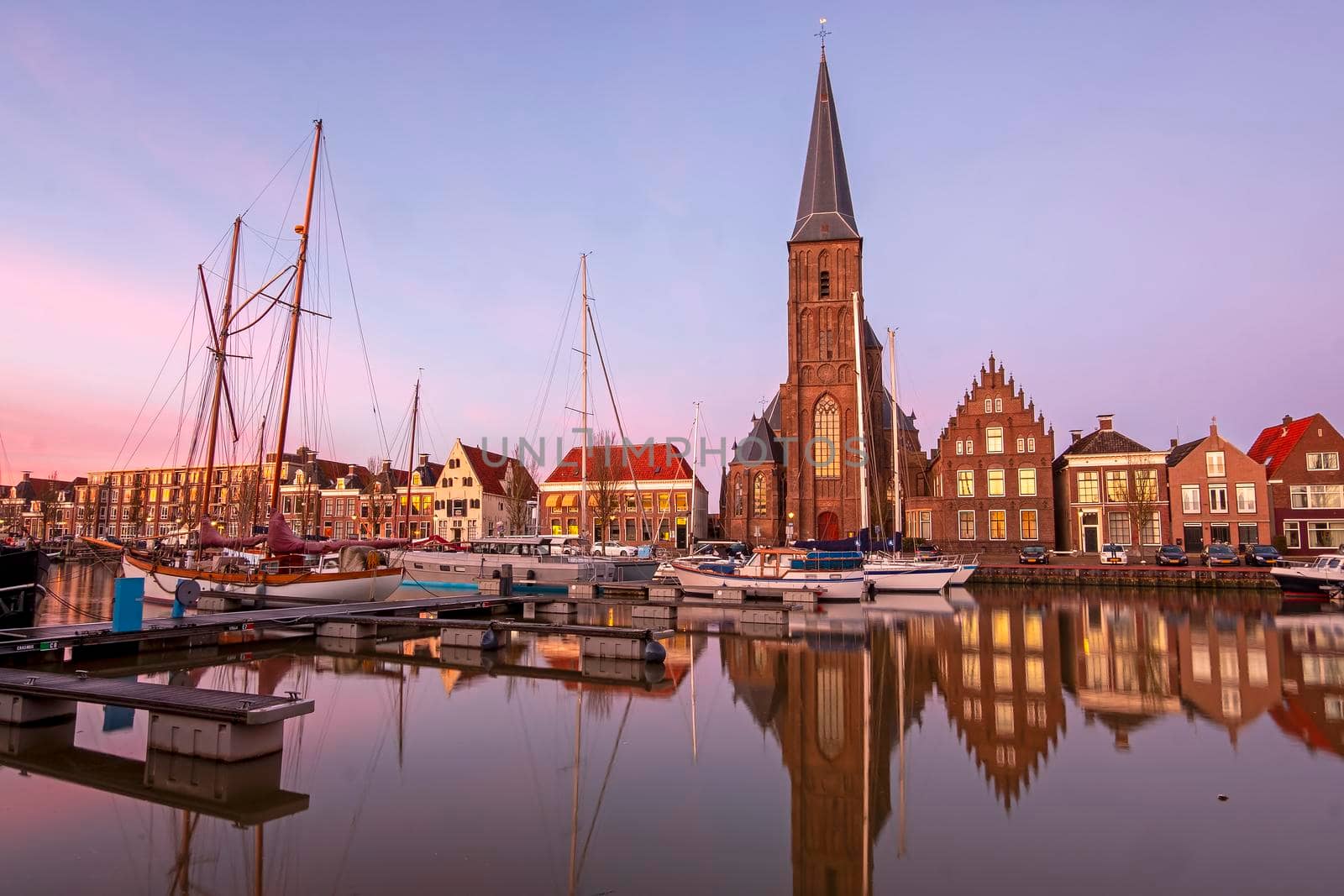 View on St. Michaels church in the city Harlingen in Friesland the Netherlands at sunset by devy