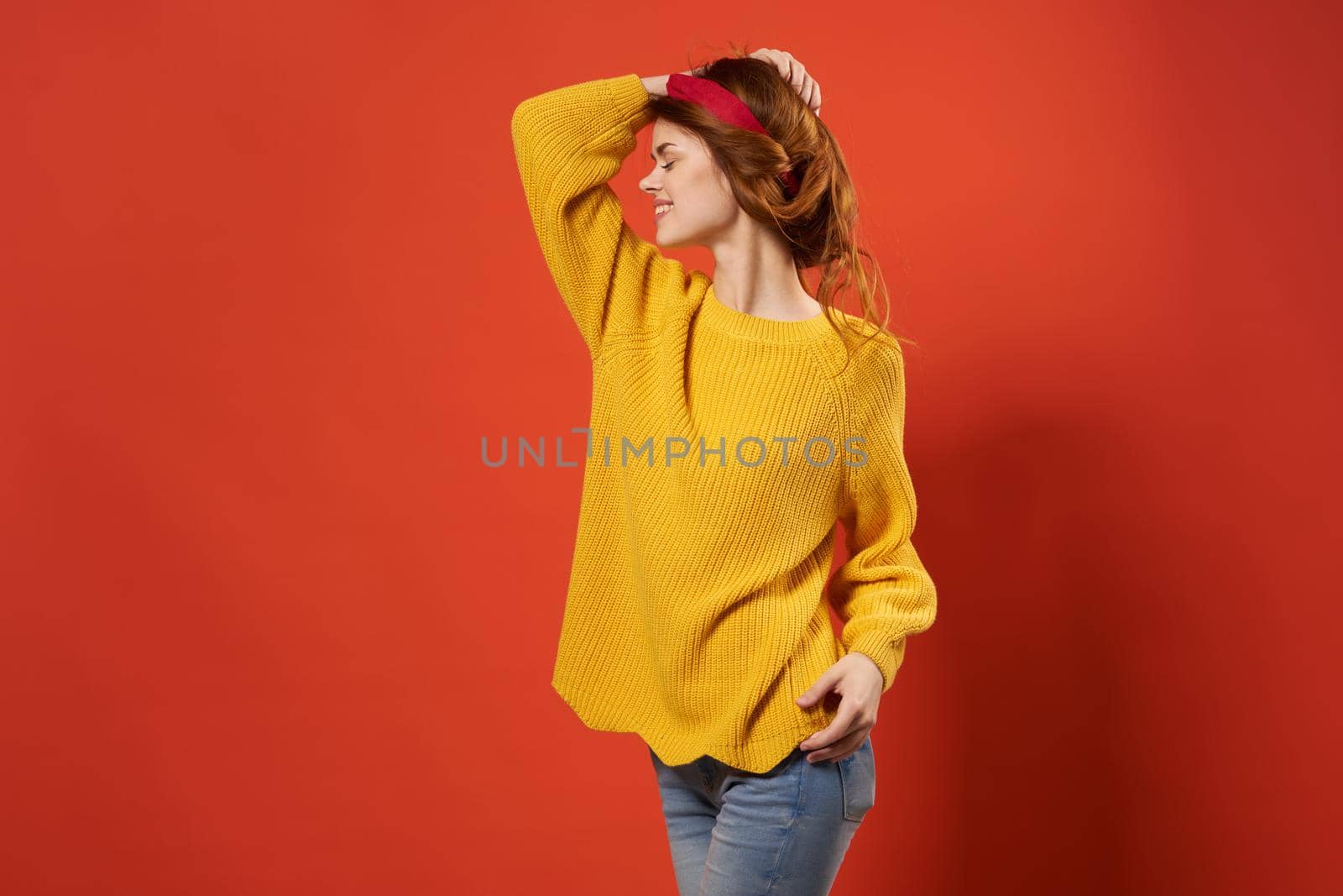 cheerful woman in yellow sweater studio fashion decoration. High quality photo