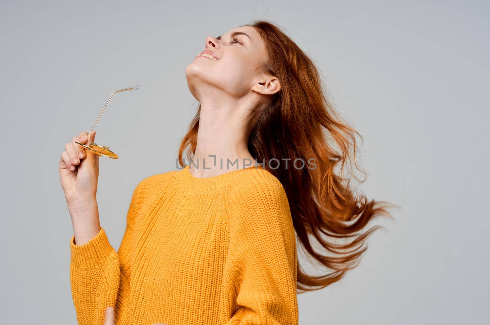 beautiful woman in yellow glasses posing fun lifestyle light background. High quality photo