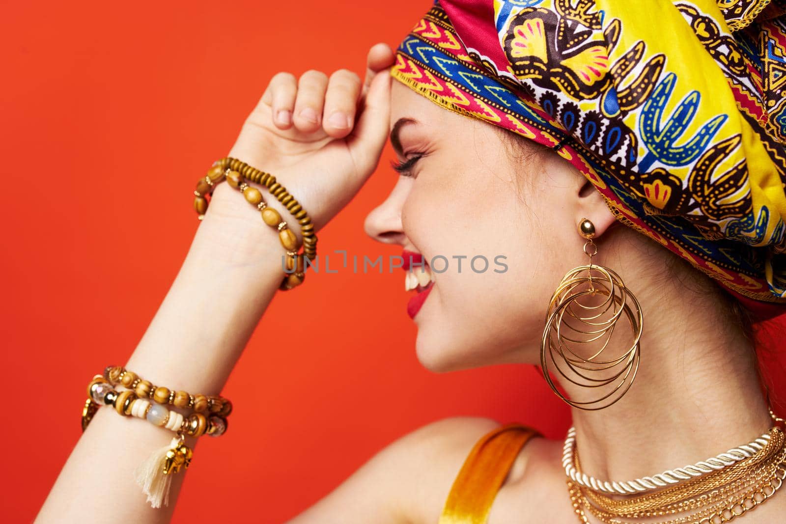 beautiful woman in multicolored turban attractive look Jewelry isolated background. High quality photo