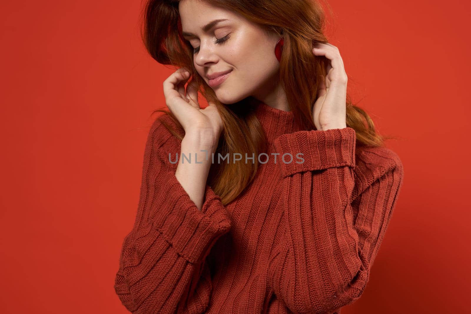 woman in red sweater fixing studio fashion lifestyle. High quality photo