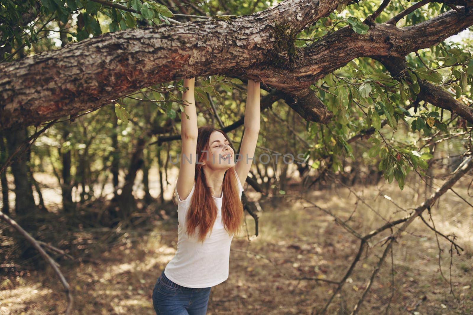 woman outdoors by the tree Sun freedom journey. High quality photo