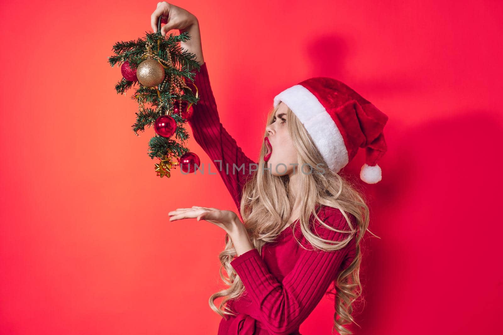 woman wearing santa claus costume christmas tree holiday decoration entertainment by SHOTPRIME