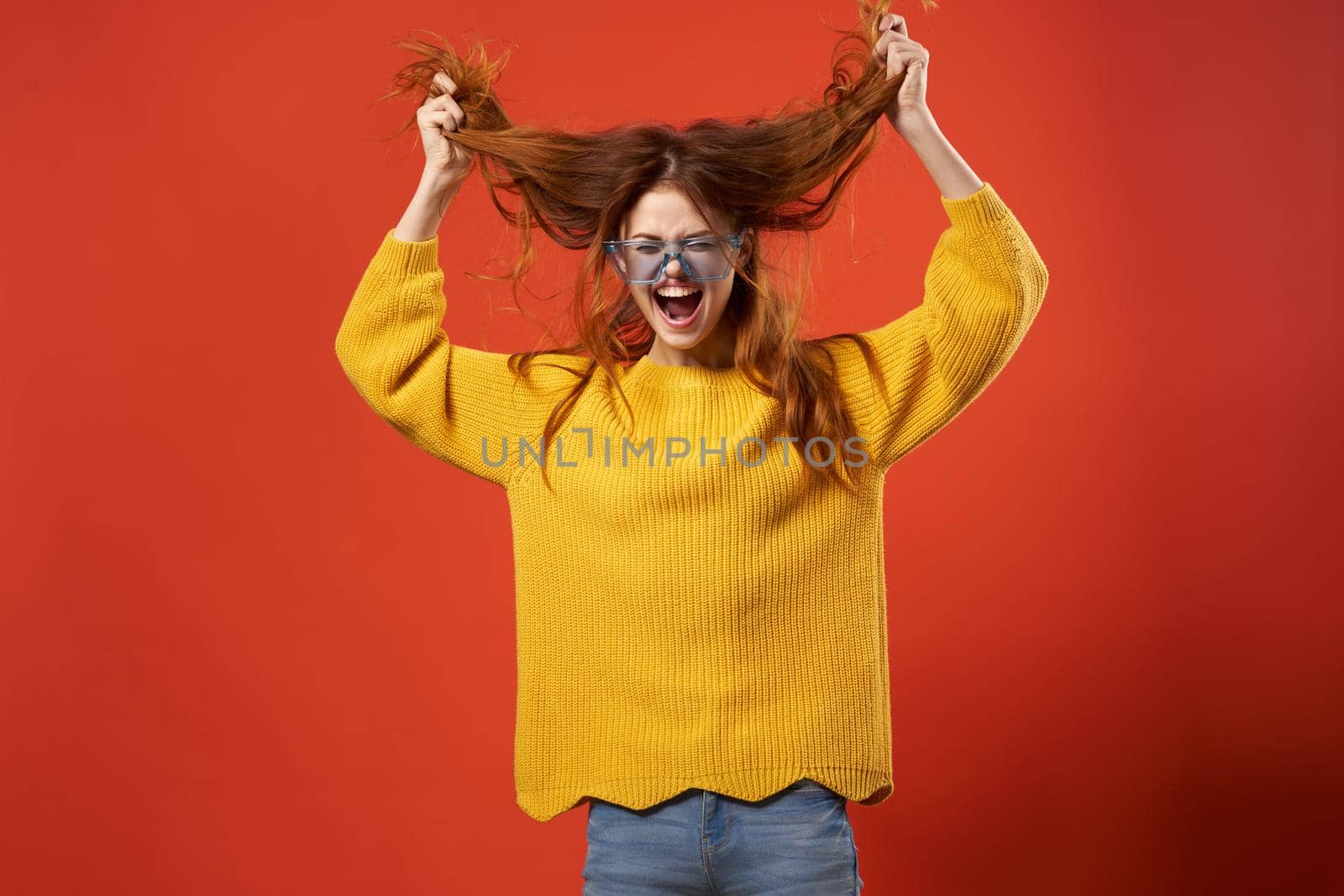 cheerful attractive woman holding hair glasses fashion studio. High quality photo