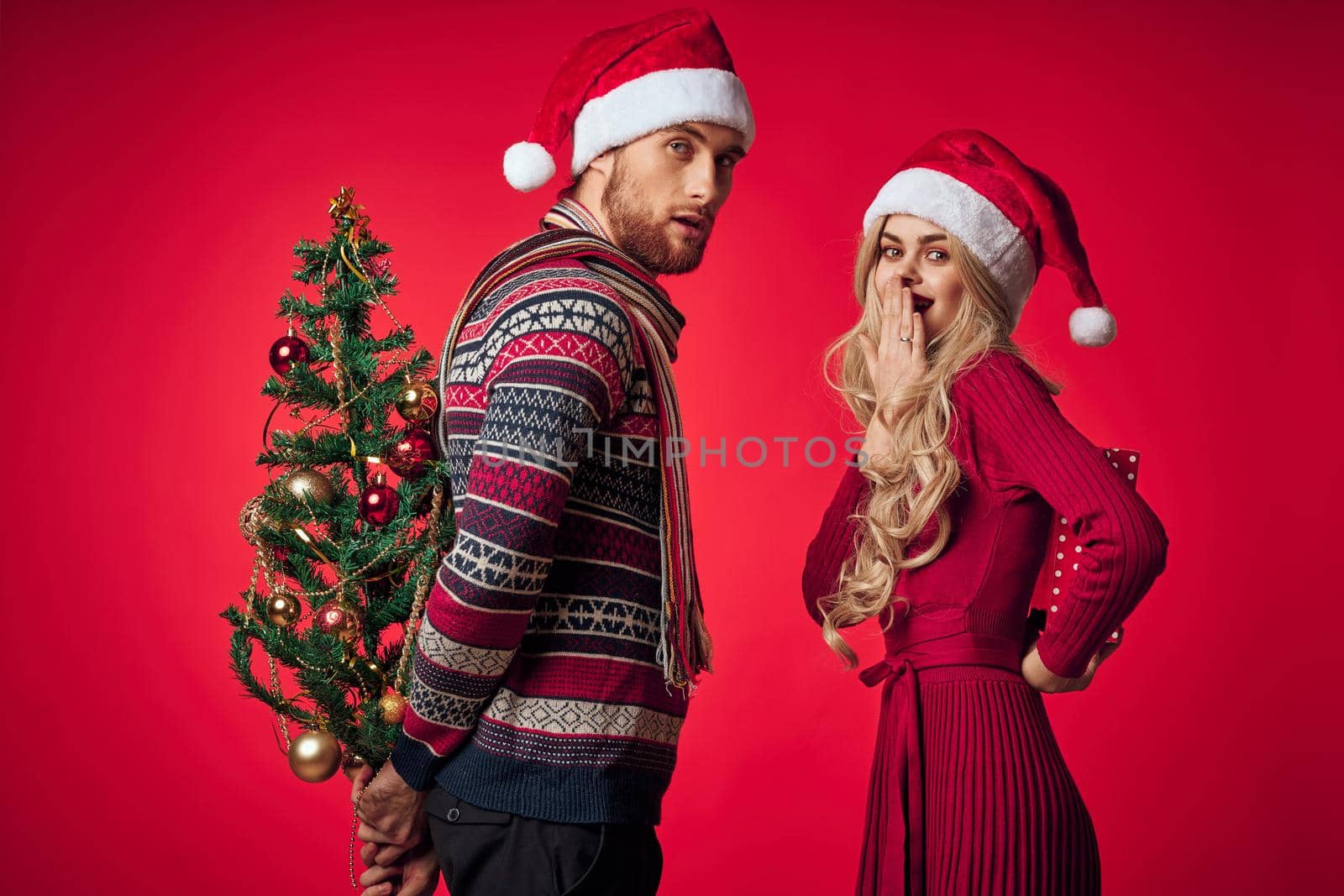 happy married couple christmas holiday decoration gifts red background by SHOTPRIME